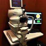 Eye examination machine with computer monitor.