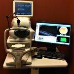 Eye examination equipment with computer monitor.